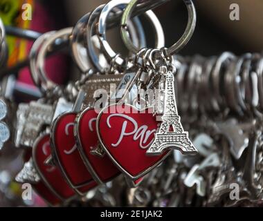 PARIS - APRIL 6:  Eiffel tower keychain with heart and Arch de Triumph for sale on April 6, 2013 in Paris, France. Eiffel tower trinket is one of the Stock Photo