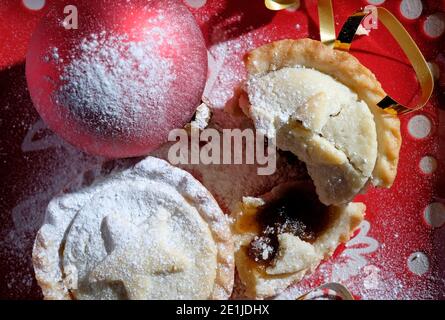 christmas mince pies, red bauble and gold tinsel Stock Photo