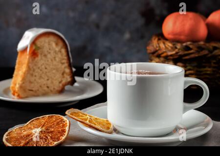 Cup of tea with oranges and a piece of homemade muffin Stock Photo