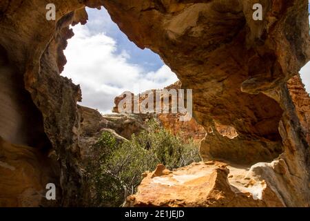 Looking through the weathered shell of a sandstone boulder, forming a small shelter, in the Cederberg Mountains of South Africa Stock Photo