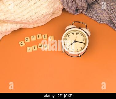 Coffee time concept with retro old alarm clock and muted faded background photo Stock Photo