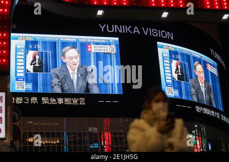 (210107) -- TOKYO, Jan. 7, 2021 (Xinhua) -- Japanese Prime Minister Yoshihide Suga speaking at a news conference is seen on screens in Tokyo, Japan, on Jan. 7, 2021. The prime minister declared a state of emergency in the Tokyo metropolitan area including Tokyo, Saitama, Chiba and Kanagawa prefectures on Thursday, authorizing tougher measures to fight a resurgence in COVID-19 infections. The state of emergency will be effective from Friday to Feb. 7, with measures including urging people to stay at home and calling for restaurants and bars to stop serving alcohol by 7 p.m. and close by 8 p.m. Stock Photo