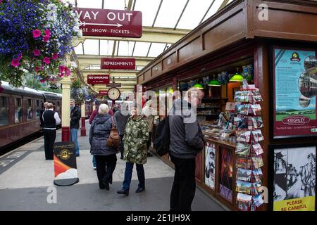 Old traditional British Railways station platform with kiosk and signage on the heritage railway line at Keighley station, West Yorkshire Stock Photo