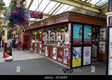 Old traditional British Railways station platform with kiosk and signage on the heritage railway line at Keighley station, West Yorkshire Stock Photo