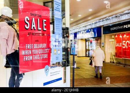 Leatherhead Surrey, London UK January 07 2021, Next Slothing Fashion Retailer Window Sale Reduction Sign Stock Photo