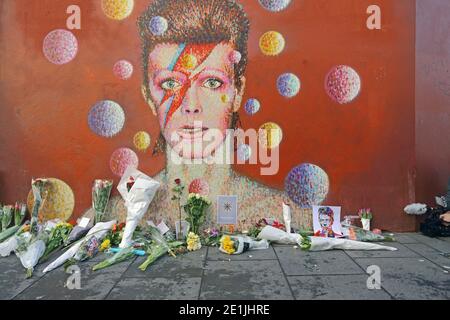 A graffiti of David Bowie as Ziggy Stardust in Brixton, London Since his death the mural has been the centre of a shrine in his memory. Stock Photo