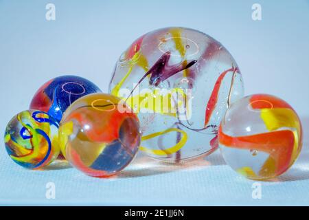 Glass marbles of translucent glass with beautiful colored mists in the glass balls, children's toys Stock Photo