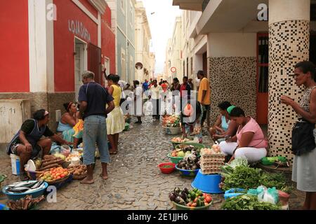 Local people selling their products along the street. Street view of Mindelo city, Sao Vincent island in Cape Verde. Stock Photo