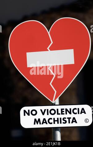Spanish language sign saying No Violencia Machista - or No Violence Against Women - in the shape of a heart with no entry sign across it. The sign is Stock Photo