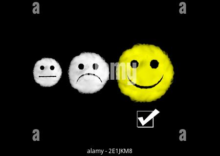 Cloud shape happy, sad and neutral emoticons with the happy face yellow on black background. Perfect for composition Stock Photo