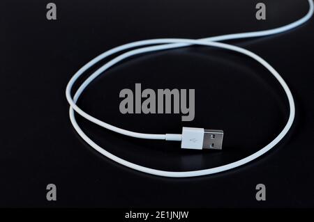 White data cable connector with USB isolated on black background Stock Photo
