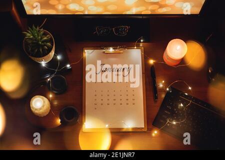 Flat lay with paper calendar january month 2021, keyboard and monitor computer on table at home. Desk calendar for January 2021 Stock Photo