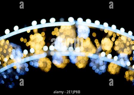 Isolated beautiful blurred street sparkles from lights of the archway on dark bacground. Stock Photo