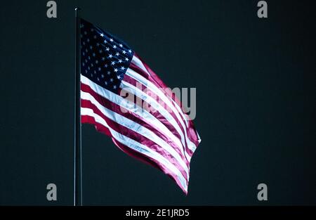 Berlin, Germany. 07th Jan, 2021. The United States flag flies atop the U.S. Embassy in Berlin. In response to the storm at the US Capitol in Washington, Berlin police have 'adjusted' their protective measures for key buildings in the capital. Credit: Christophe Gateau/dpa/Alamy Live News