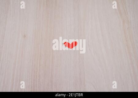 red paper heart, scarlet little heart, valentine's day, red heart on wooden background Stock Photo