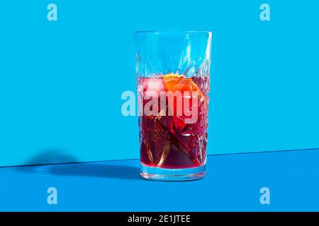 A glass of red vermouth on a blue background Stock Photo