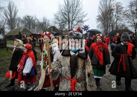Ukrainians dressed in folk costumes singing Christmas songs during the