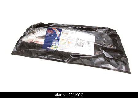 Whole Scottish salmon fish (1kg )in sealed plastic packaging, isolated on a white studio background. Stock Photo