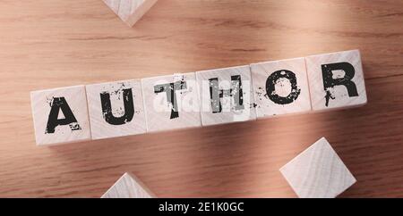 Author word made of wooden cubes with letters on a wooden desk. Stock Photo
