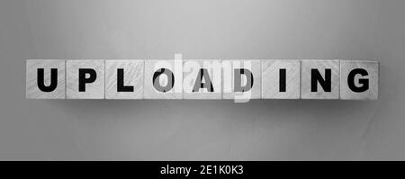 uploading word on wooden cubes. Online downloadable Internet resources concept Stock Photo