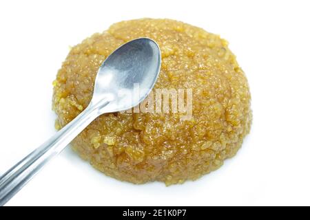 Sweet Pongal made on a white background on a festive day and silver spoon on top of Pongal Stock Photo