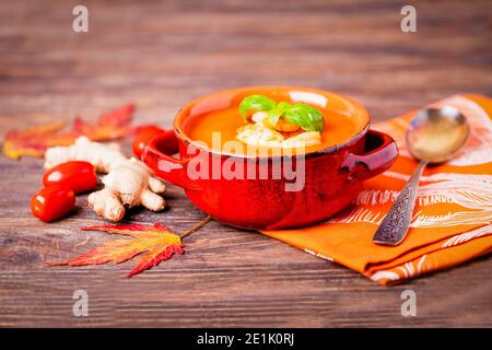 Homemade tomato soup with ginger, shrimps and basil, rustic style, copy space Stock Photo