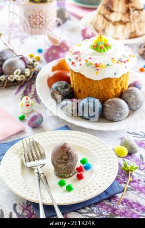Festive table setting. Easter table with Easter orthodox cakes and Easter eggs. Stock Photo