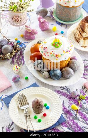 Festive table setting. Easter table with Easter orthodox cakes and Easter eggs. Stock Photo
