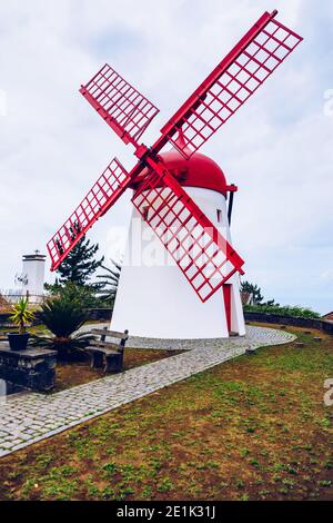 Old windmill Red Peak Mill in Bretanha (Sao Miguel, Azores). Traditional white wind mill with red roof and wings in village Bretanha, Sao Miguel Islan Stock Photo