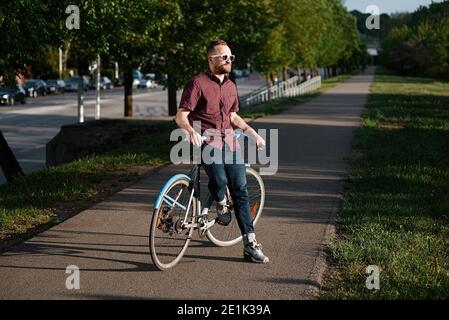 A handsome male with bicycle and backpack Stock Photo