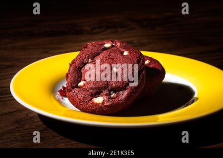 Red Velvet cookie with white chocolate on the dark wooden table Stock Photo