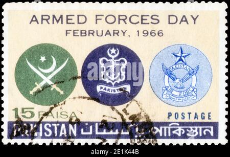 Saint Petersburg, Russia - November 12, 2020: Stamp printed in the Pakistan with the image of the Army, Navy and Air Force Crests, circa 1966 Stock Photo