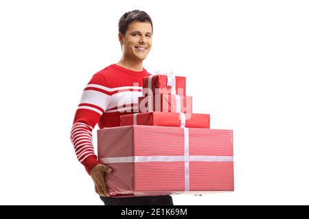 Guy in a sweater holding a pile of presents isolated on white background Stock Photo