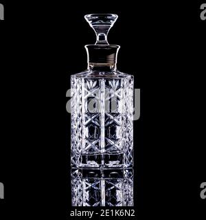 Straight sided glass decanter on black background Stock Photo
