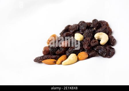 A healthy snack of a mixture of nuts and raisins on a white Stock Photo