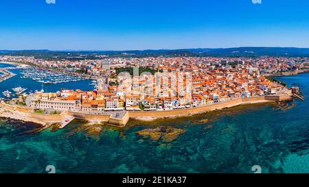 Aerial view over Alghero old town, cityscape Alghero view on a beautiful day with harbor and open sea in view. Alghero, Italy. Panoramic aerial view o