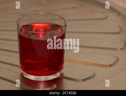 A cup of red compote in the kitchen. Health benefits. Stock Photo