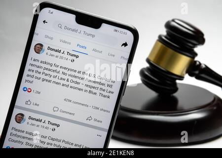 Donald Trump's Facebook account and his posts about violence in the US Capitol seen on the smartphone and a Stock Photo