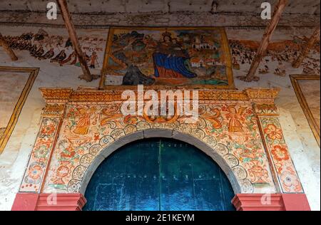 Entrance of the colonial church of Chinchero with its fresco paintings mural, Sacred Valley of the Inca, Cusco province, Peru. Stock Photo