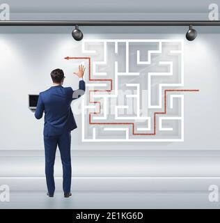 The businessman is looking for ways to escape from maze labyrinth Stock Photo