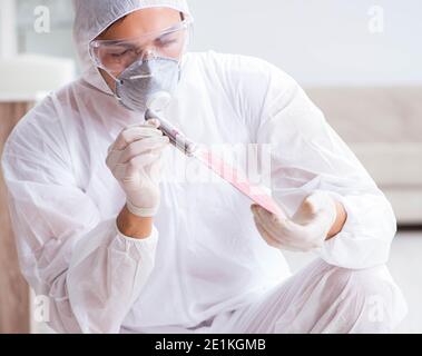 The forensic expert at crime scene doing investigation Stock Photo