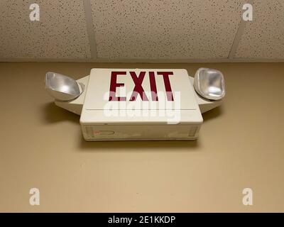 Interior exit light and sign in a building Stock Photo