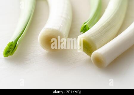 Allium porrum fresh organic Leek on the kitchen cutting table close up Stock Photo