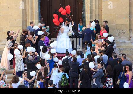 Newly weds kissing outside the St. George's Basilica in Victoria (Gozo), Malta where they just got married Stock Photo