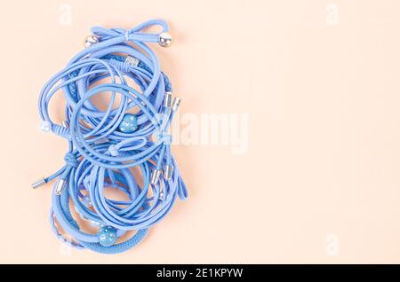 Set of blue fabric rubber bands. Elastic hair ties in vibrant colors on pink background. Stock Photo