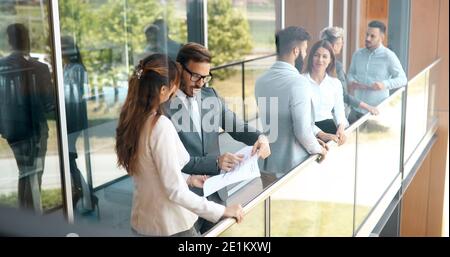 Business colleagues collaborating and discussing project plans Stock Photo