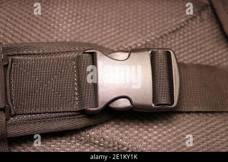 Black plastic buckle on the backpack. Plastic zip lock. Photo toned sepia. Close-up. Stock Photo