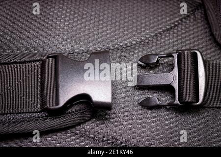 Black plastic buckle on the backpack. Plastic zip lock. Close-up. Stock Photo