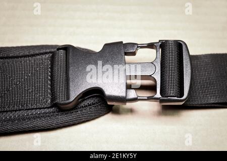 Black plastic buckle fastex for backpacks. Accessories for backpacks, fastener close-up. Stock Photo