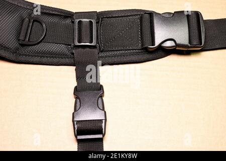 Black plastic buckle fastex for backpacks. Accessories for backpacks, fastener close-up. Stock Photo